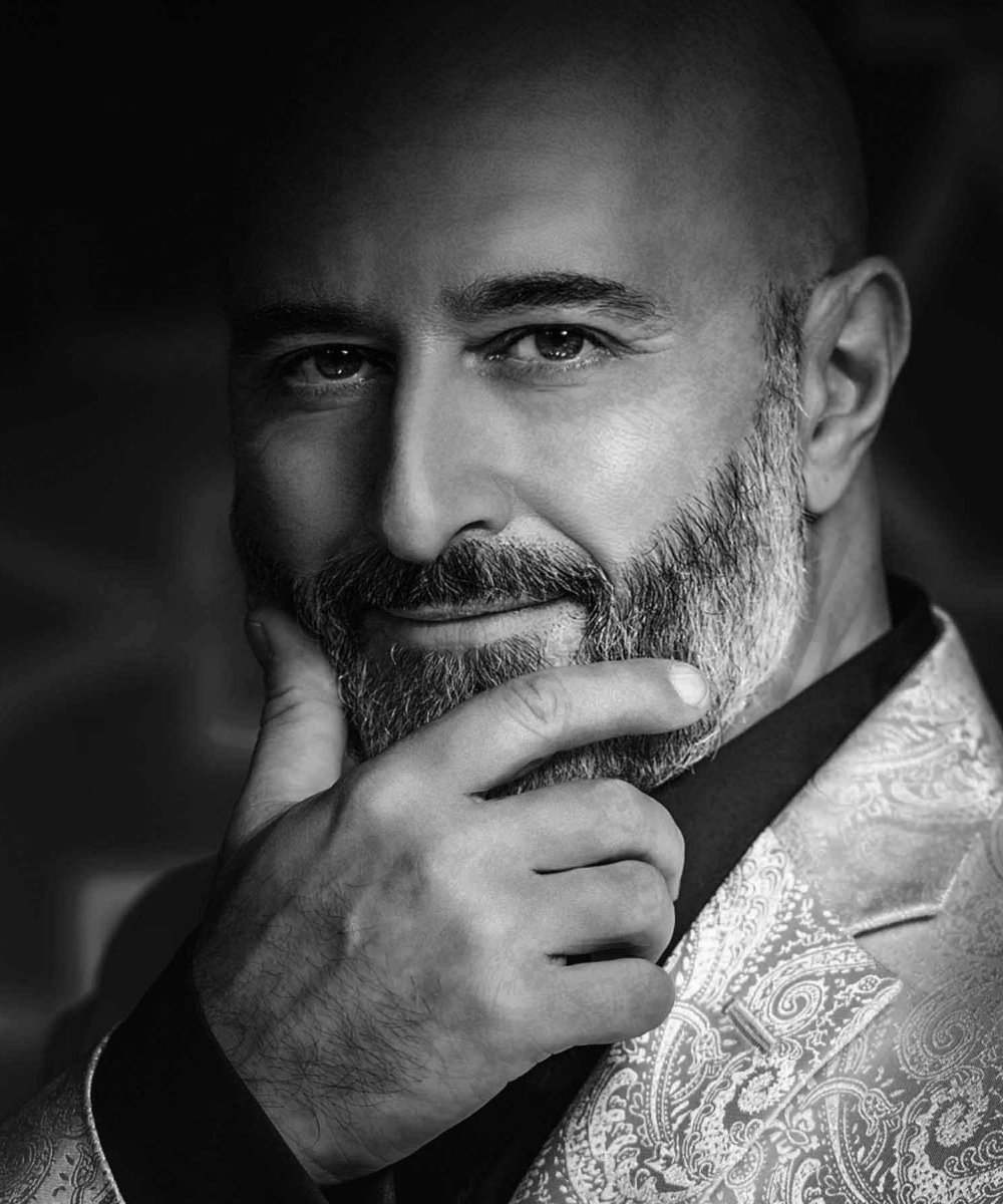 Photo of Greg Paulnack stroking his salt-and-pepper beard